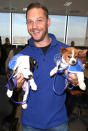 <p>The <em>Peaky Blinders</em> actor is always willing to make sacrifices to help animal charities. Posing for a photograph with these two cuties, at the BGC Annual Global Charity Day in London in <span>support of Battersea Dogs and Cats Home, was light-lifting. (Photo by Tim P. Whitby/Getty Images)</span> </p>