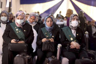 Judges attend a swearing-in ceremony before Egypt’s State Council’s chief judge Mohammed Hossam el-Din in a celebratory event in Cairo, Egypt, Tuesday, Oct. 19, 2021. Ninety eight women have become the first female judges to join the council, one of the country’s main judicial bodies. The swearing-in came months after President Abdel Fattah el-Sissi asked for women to join the State Council and the Public Prosecution, the two judicial bodies that until recently were exclusively male. (AP Photo/Tarek Wajeh)