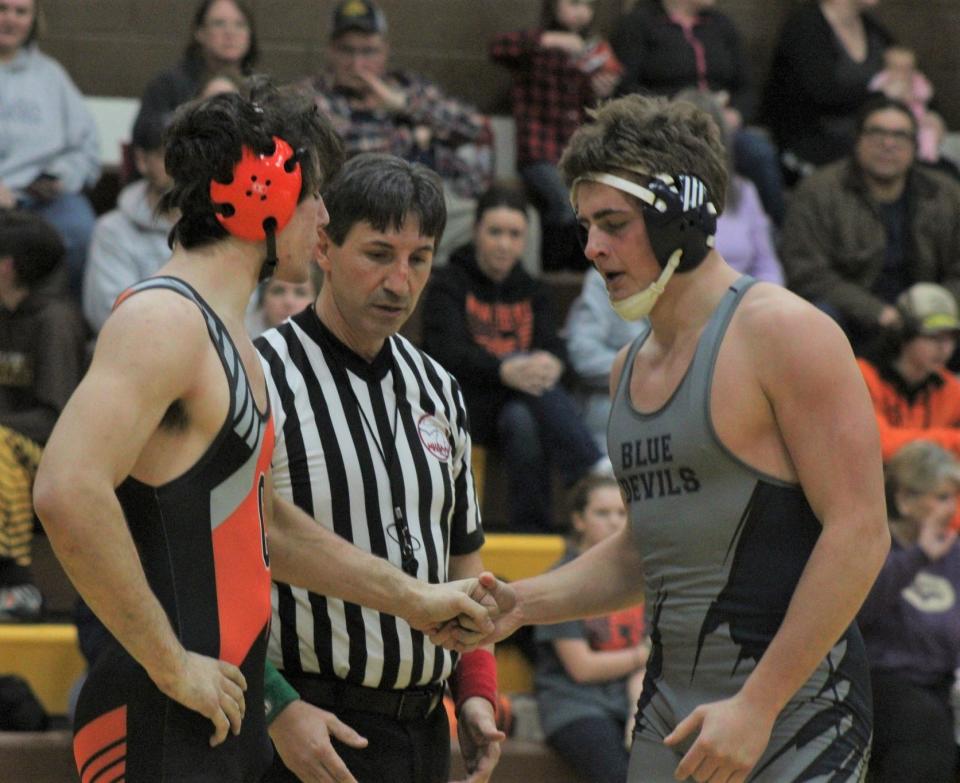 Cheboygan senior 215-pounder Robert LaPointe (left) shakes hands with his Sault opponent after LaPointe picked up a pin in the first round on Wednesday.