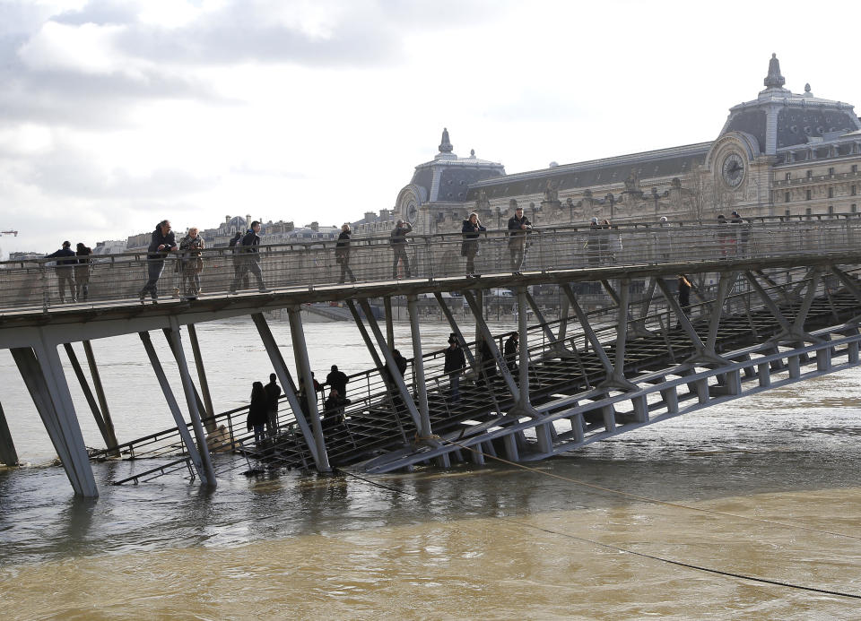 <p>People watch the Seine river from the Leopold-Sedar-Senghor bridge in Paris, France, Friday, Jan. 26, 2018. (Photo: Michel Euler/AP) </p>