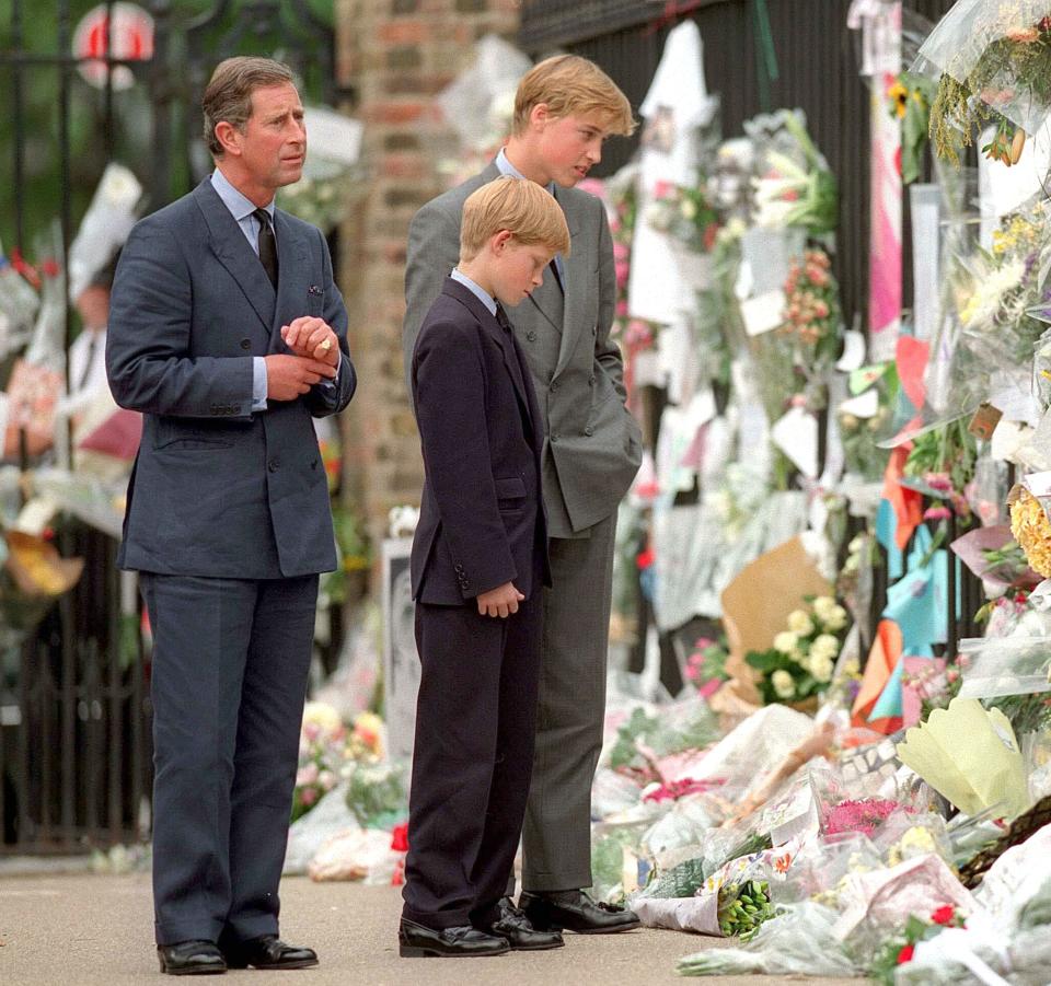 King Charles III, Prince William, and Prince Harry look at floral tributes for Princess Diana in 1997.