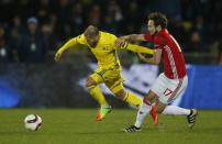 <p>Manchester United’s Daley Blind tries to stop Rostov’s Timofei Kalachev</p>