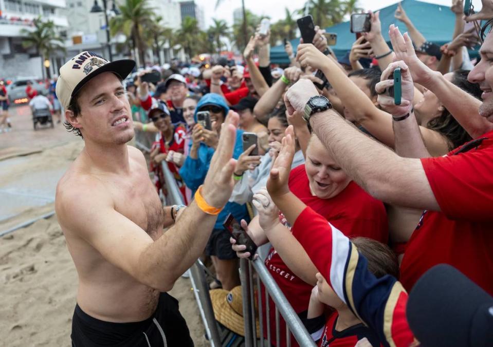 Florida Panthers center Nick Cousins (21) high-fives fans during the Stanley Cup victory parade at the Fort Lauderdale Beach Park off A1A on Sunday, June 30, 2024, in Fort Lauderdale, Fla. The parade was held to celebrate the Florida Panthers after they defeated the Edmonton Oilers in Game 7 of the Stanley Cup Final.