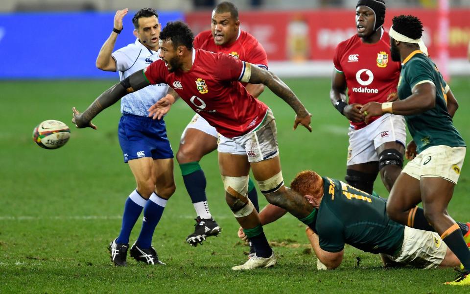 Courtney Lawes of the British and Irish Lions offloads the ball as Steven Kitshoff of South Africa attempts a tackle during the first test of the British and Irish Lions tour match between South Africa and British and Irish Lions at Cape Town Stadium in Cape Town, South Africa