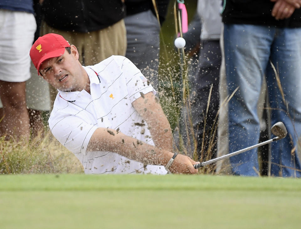 USA's Patrick Reed hits out of a bunker during a practice session ahead of the President's Cup Golf tournament in Melbourne, Tuesday, Dec. 10, 2019. (AP Photo/Andy Brownbill)