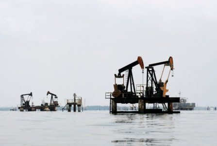 FILE PHOTO: Oil pumps are seen in Lake Maracaibo, in Lagunillas, Ciudad Ojeda, in the state of Zulia, Venezuela, March 20, 2015.REUTERS/Isaac Urrutia/File Photo - S1BETFVJVBAB/File Photo