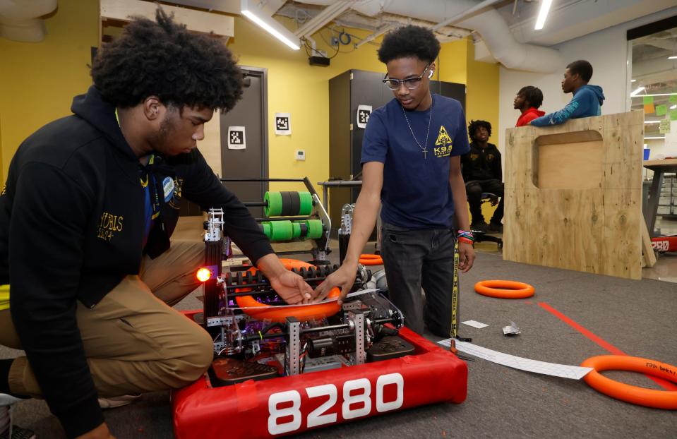 Xavier McDonald, 16, left, and Aslan Derring, 14, both of Detroit, and students at Marygrove High School, work on problem solving an issue with their FIRST Robotics robot at the school on Wednesday, March 27, 2024.