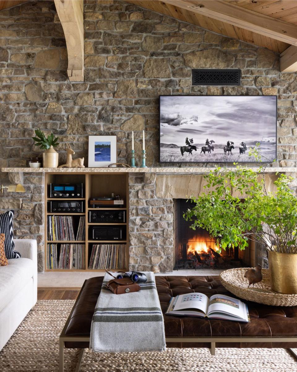 a living room with stone walls in lake pulaski, minnesota