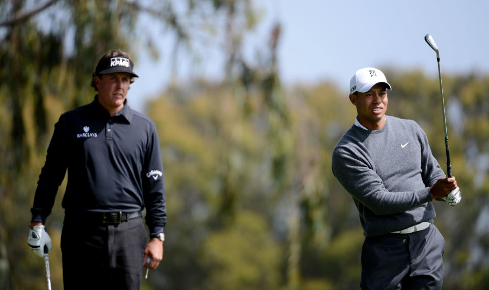 Tiger Woods of the United States watches a shot on the second hole as Phil Mickelson looks on during the first round of the 112th U.S. Open at The Olympic Club on June 14, 2012 in San Francisco, California. (Photo by Harry How/Getty Images)