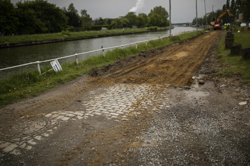 Constructions crews remove an old cobblestone lane to replace it with an asphalt road designated only for for bikes, during a gradual lifting of a lockdown to prevent the spread of the coronavirus, COVID-19, in Brussels, Monday, May 4, 2020. As European cities gradually relax lockdown measures, Brussels authorities intend to take advantage of the coronavirus health crisis to turn the EU institutions capital into a cycling-friendly greener place. (AP Photo/Francisco Seco)