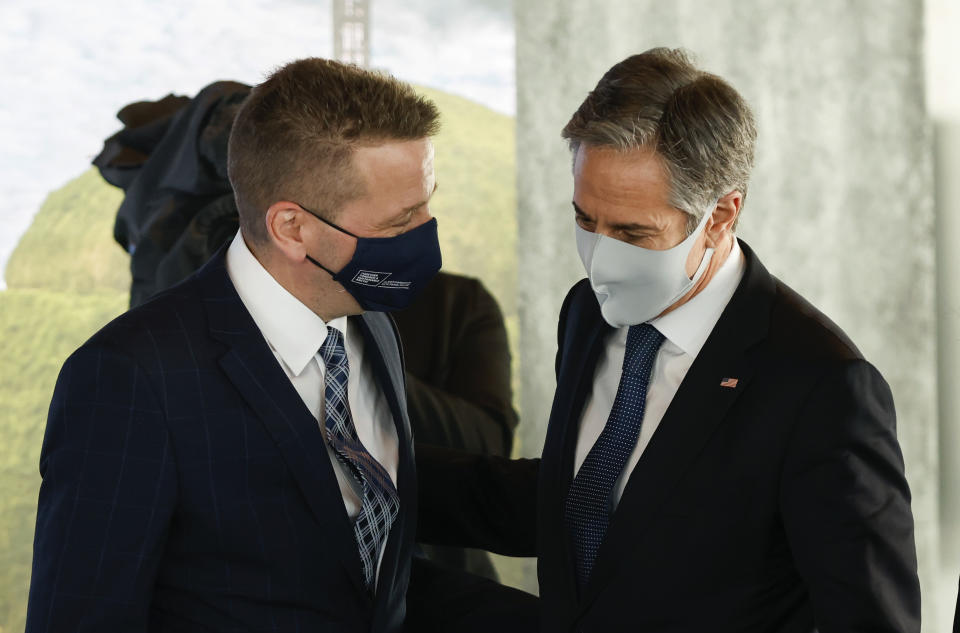 US Secretary of State Antony Blinken, right is greeted by Icelandic Minister of Foreign Affairs Gudlaugur Thor Thordarson as he arrives for the Arctic Council Ministerial Meeting in Reykjavik, Iceland, Thursday, May 20, 2021. Top diplomats from the United States and Russia sparred politely in Iceland during their first face-to-face encounter, which came as ties between the nations have deteriorated sharply in recent months. (AP Photo/Brynjar Gunnarsson, Pool)