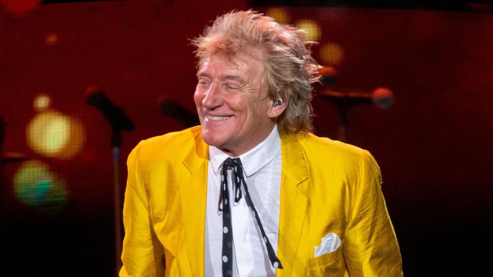 Rod Stewart performing in a yellow suit