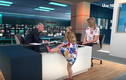 Iris Wronka attempts to climb on the desk during a live broadcast of ITV <em>Lunchtime News</em>. (Photo: ITV News)