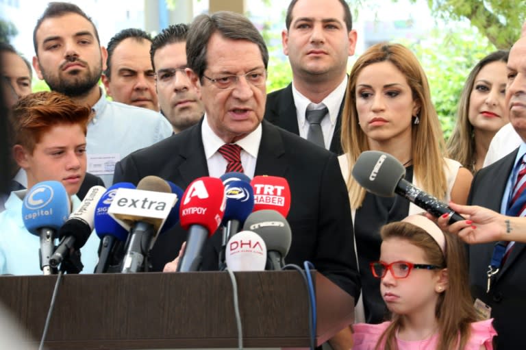 The rightwing Democratic Rally (DISY) of Cypriot President Nicos Anastasiades (pictured, C) has taken 30 percent of the vote and 18 seats in the 56-seat parliament, down two on the last election in 2011