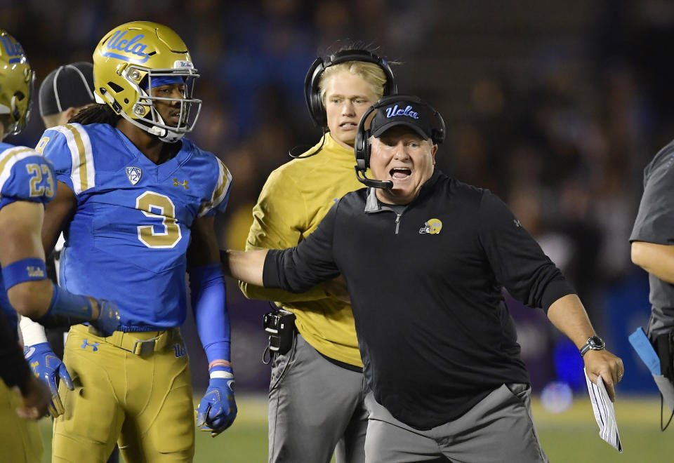 UCLA head coach Chip Kelly, right, tries to get defensive back Rayshad Williams into the game during the second half of an NCAA college football game against Arizona Saturday, Oct. 20, 2018, in Pasadena, Calif. UCLA won 31-30. (AP Photo/Mark J. Terrill)