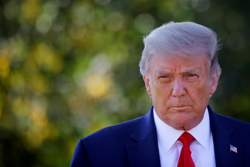 FILE PHOTO: U.S. President Donald Trump approaches reporters as he departs on campaign travel to Minnesota from the South Lawn at the White House in Washington, U.S.