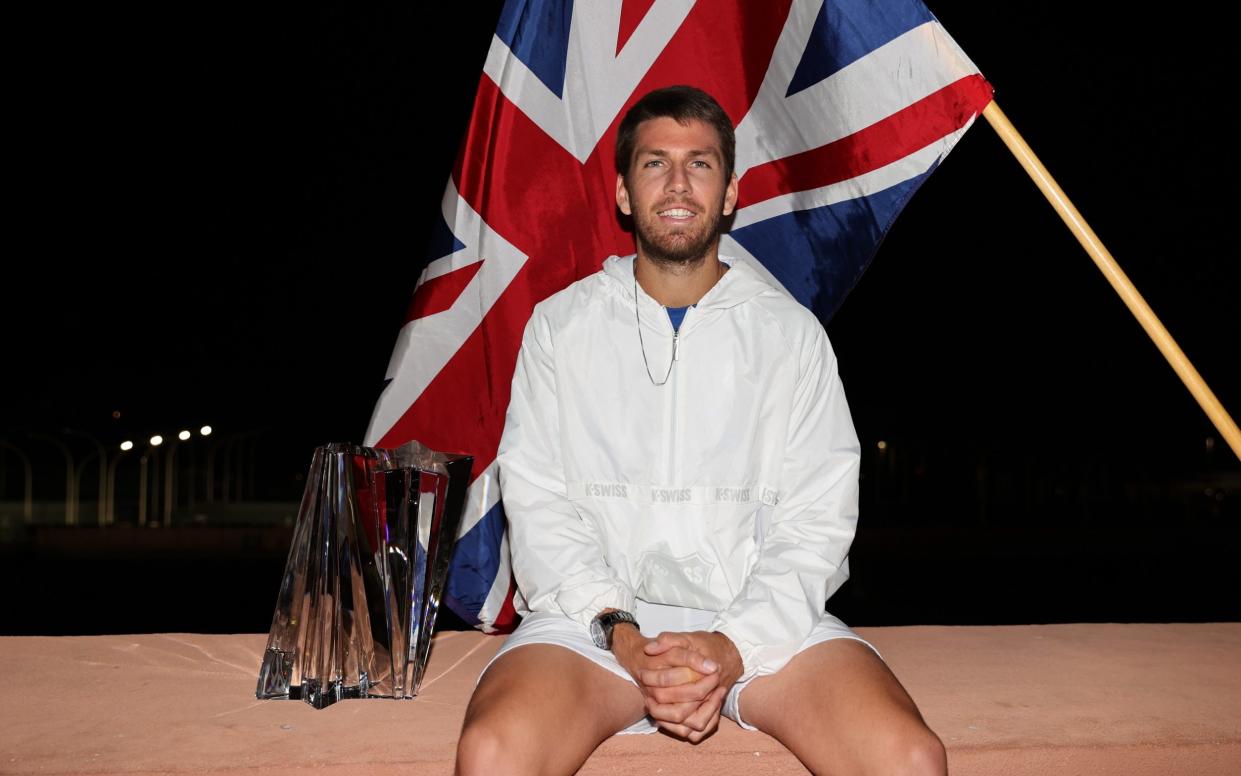 Cameron Norrie of Great Britain poses for an off court photograph with his winners trophy after his three set victory against Nikoloz Basilashvili - Getty Images