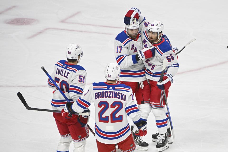 New York Rangers defenseman Erik Gustafsson (56) celebrates with right wing Blake Wheeler (17), right wing Will Cuylle (50) and center Jonny Brodzinski (22) after scoring against the Minnesota Wild during the first period of an NHL hockey game Saturday, Nov. 4, 2023, in St. Paul, Minn. (AP Photo/Craig Lassig)