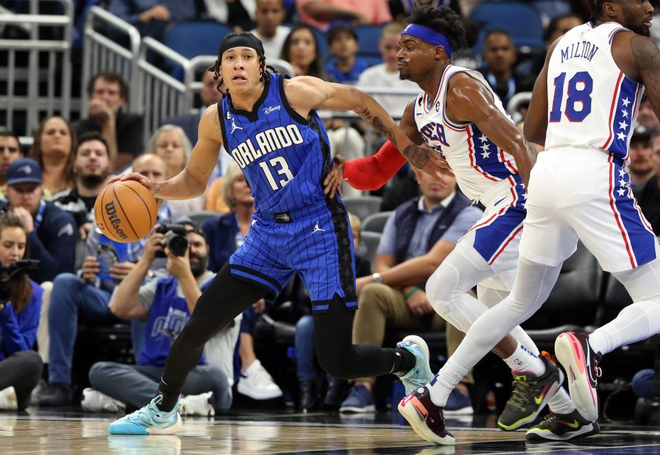 Orlando Magic guard R.J. Hampton drives to the basket as Philadelphia 76ers forward Danuel House Jr. defends during the first quarter Nov. 27, 2022 in Orlando.