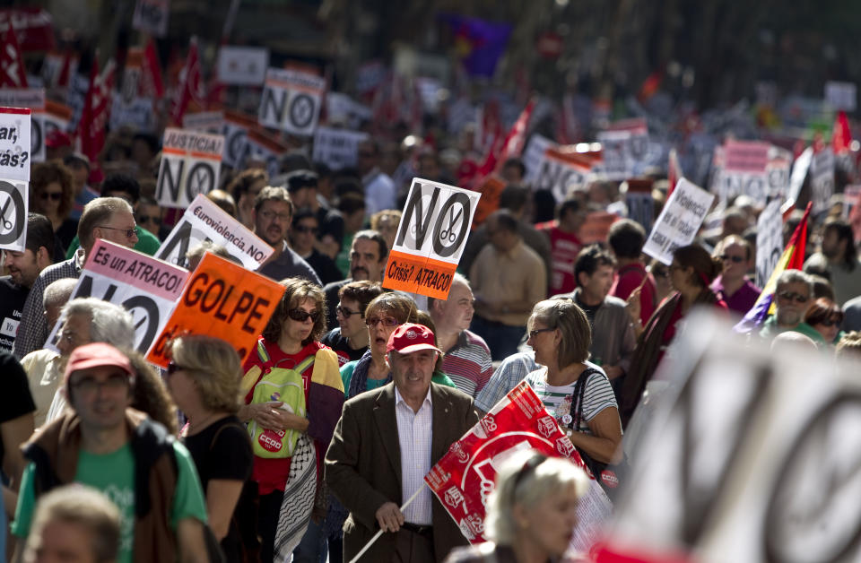 People hold banners against cuts during a demonstration in Madrid, Spain, Sunday, Oct. 7, 2012. Thousands of people called by 150 organizations are marching in 56 Spanish cities to protest punishing austerity cuts they say will only increase unemployment and job insecurity. (AP Photo/Alberto Di Lolli)