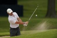 Rory McIlroy, of North Ireland, hits from the bunker on the 17th hole during a practice round for the PGA Championship golf tournament, Tuesday, May 17, 2022, in Tulsa, Okla. (AP Photo/Matt York)