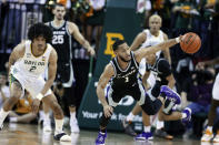 Kansas State guard Markquis Nowell, right, reaches for a loose ball with Baylor guard Kendall Brown, left, in the first half of an NCAA college basketball game, Tuesday, Jan. 25, 2022, in Waco, Texas. (Rod Aydelotte/Waco Tribune Herald, via AP)