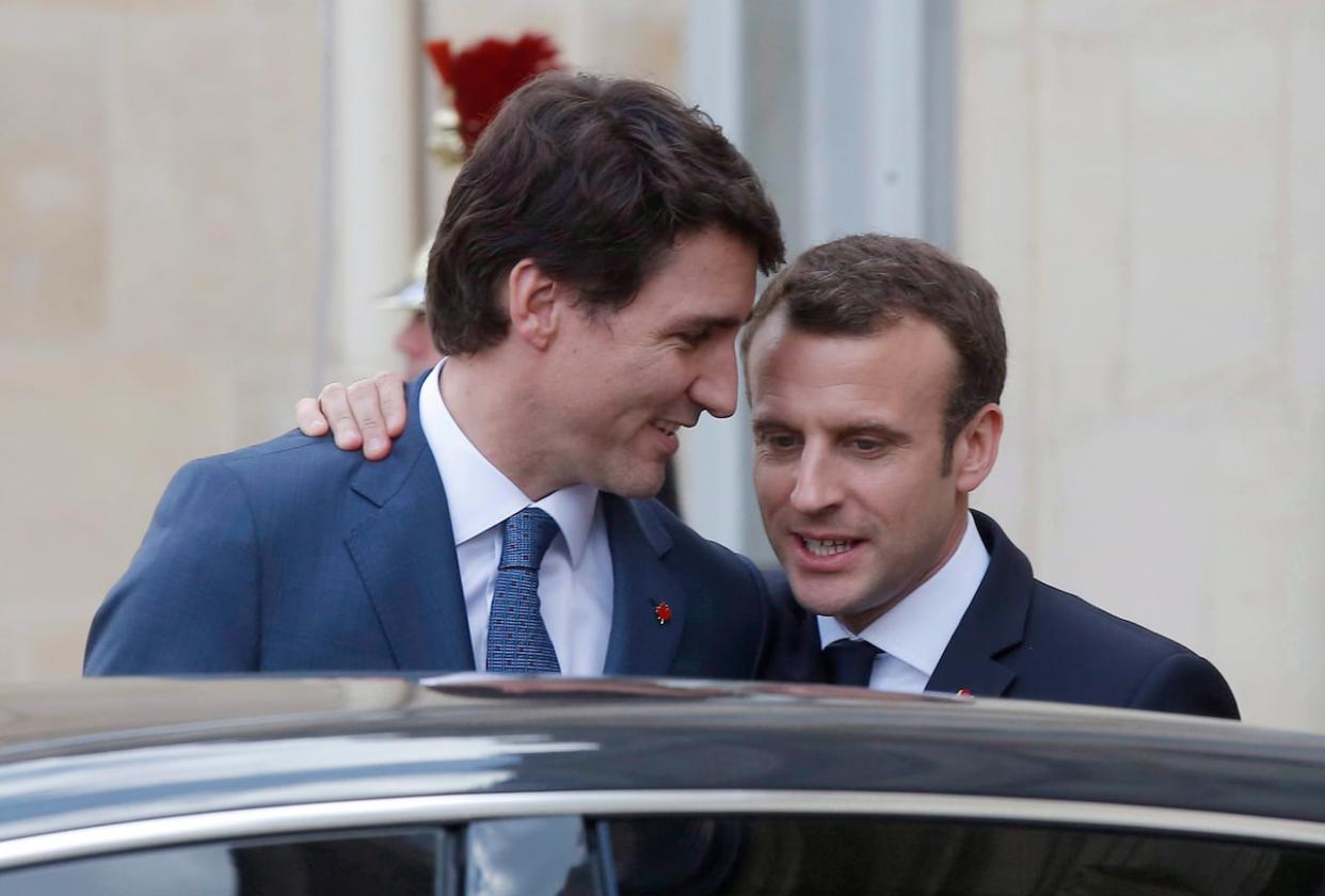 Prime Minister Justin Trudeau, left, says goodbye to French President Emmanuel Macron after a meeting at the Elysee Palace in Paris on Monday, April 16, 2018. Macron is preparing to visit Canada this summer, Radio-Canada reports. (Michel Euler/Associated Press - image credit)