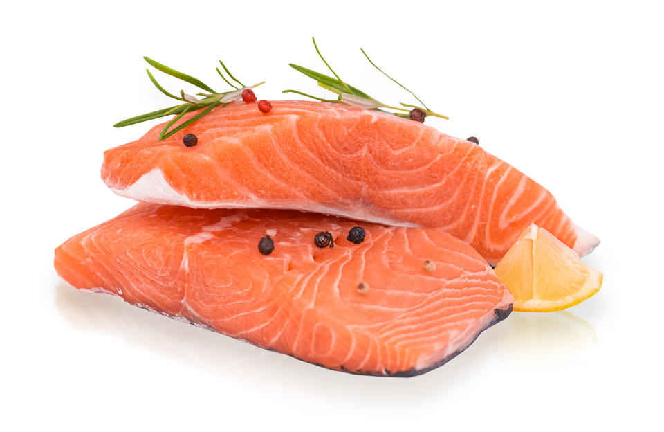 Fresh Salmon Pieces Seasoned with Rosemary, Pepper and Lemmon Isolated on White Background