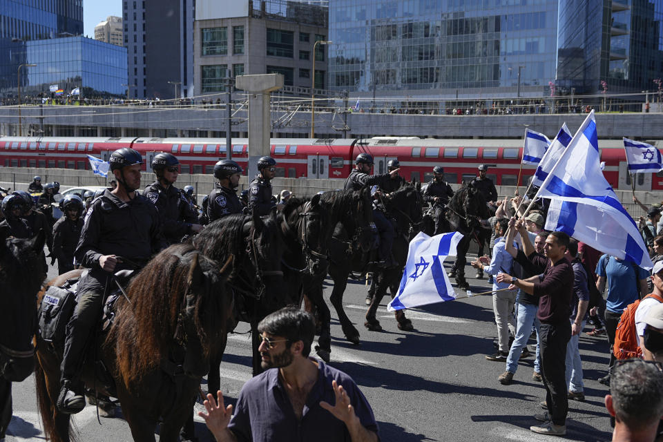 Mounted police are deployed as Israelis block a highway to protest against plans by Prime Minister Benjamin Netanyahu's government to overhaul the judicial system, in Tel Aviv, Israel, Thursday, March 9, 2023. (AP Photo/Ohad Zwigenberg)