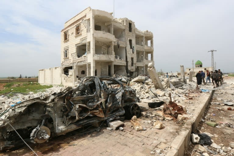 Syrians walk through the rubble following an alleged bombing by the Islamic State (IS) group in Marea, northern Aleppo in April