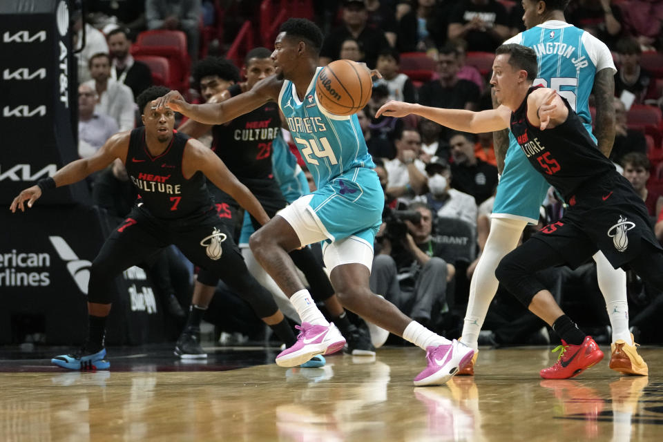 Charlotte Hornets forward Brandon Miller (24) drives to the basket as Miami Heat guard Kyle Lowry and forward Duncan Robinson (55) defend during the first half of an NBA basketball game, Wednesday, Dec. 13, 2023, in Miami. (AP Photo/Lynne Sladky)