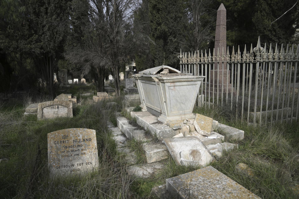 A grave lies in ruins where vandals desecrated more than 30 graves at a historic Protestant Cemetery on Jerusalem's Mount Zion in the Old City of Jerusalem, Wednesday, Jan. 4, 2023. Israel's foreign ministry called the attack an "immoral act" and "an affront to religion." Police officers were sent to investigate the profanation. (AP Photo/ Mahmoud Illean)