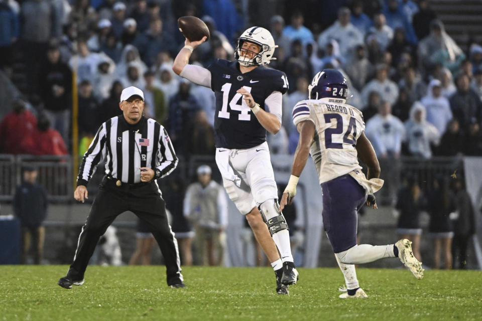 Penn State quarterback Sean Clifford (14) throws a pass while being pressured by Northwestern defensive back Rod Heard II (24) during the second half of an NCAA college football game Saturday, Oct. 1, 2022, in State College, Pa. (AP Photo/Barry Reeger)
