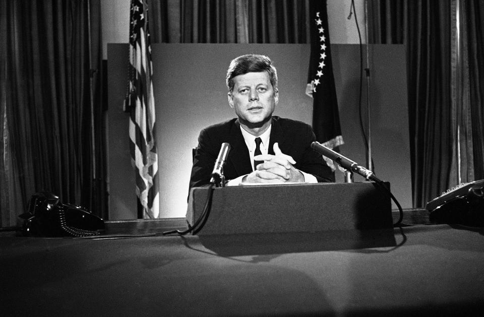 FILE - In this July 26, 1963 file photo, U.S. President John F. Kennedy sits behind microphones at his desk in Washington after finishing his radio-television broadcast to the nation on the nuclear test ban agreement initialed by negotiators in Moscow. (AP Photo/John Rous)