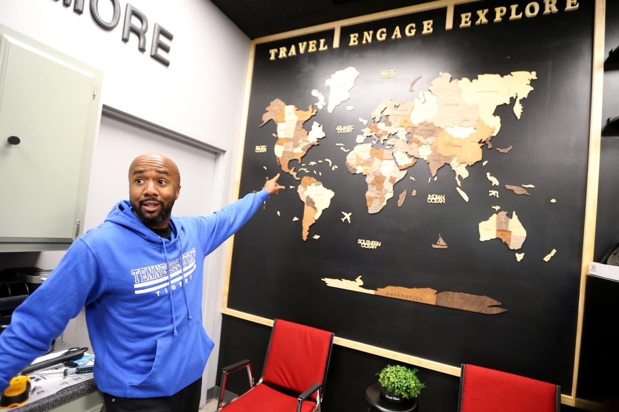 Brian Frazier, 43, a Tennessee State University graduate and resident of South Bend, points out the world map he has in his studio Monday, Aug. 23, 2023, to inspire students to think about the world outside the area. Frazier is organizing a series of events as the University of Notre Dame plays Tennessee State on Saturday in a matchup of the Irish and a Historically Black College or University. The events will include a TSU pep rally Friday at Jon R. Hunt Plaza and meetings with high school students and alumni from HBCUs. Frazier has a studio in South Bend.