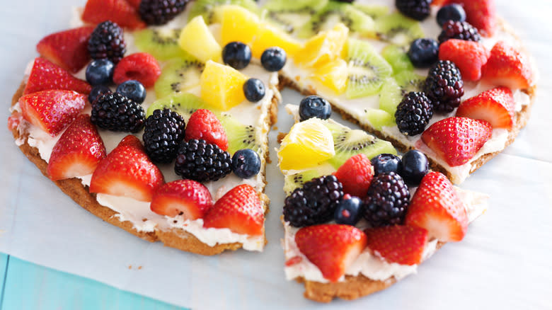 Cream cheese and different fruit on a dessert pizza