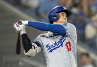 Los Angeles Dodgers designated hitter Shohei Ohtani hits a line drive to second base during fourth-inning baseball game action against the Toronto Blue Jays in Toronto, Sunday, April 28, 2024. (Frank Gunn/The Canadian Press via AP)