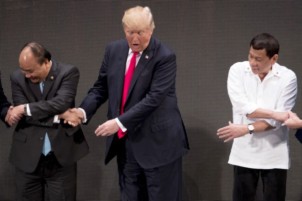 Donald Trump was totally caught off guard by this awkward handshake. Photo: AAP