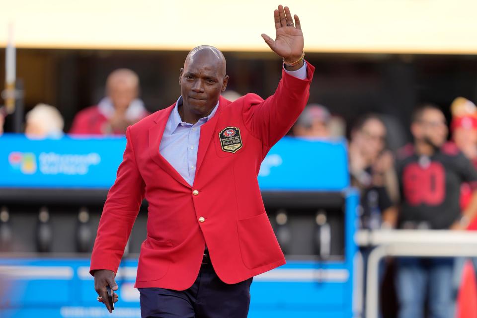 Former San Francisco 49ers player Bryant Young waves during a ceremony for his induction into the team's Hall of Fame during halftime of an NFL football game between the 49ers and the Arizona Cardinals in Santa Clara, Calif., Sunday, Nov. 7, 2021. (AP Photo/Tony Avelar)