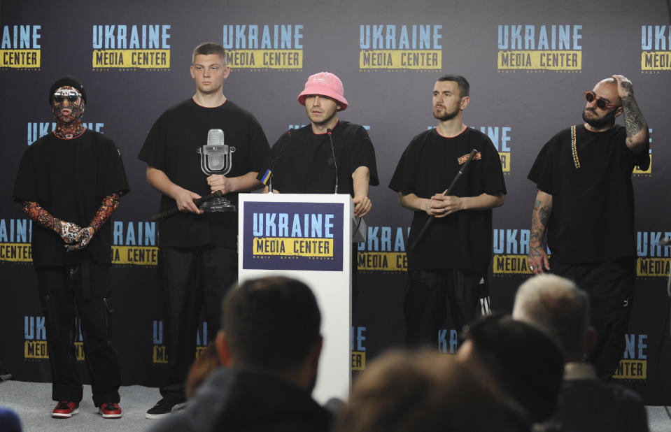 Oleh Psiuk, center, frontman of Ukraine's Kalush Orchestra winner of the Eurovision Song Contest, and other members of his band attend a news conference in Lviv, Ukraine, Tuesday, May 17, 2022. (AP Photo/Mykola Tys)