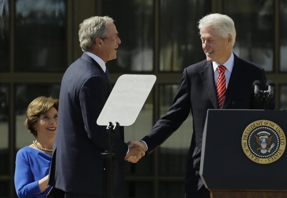 Former president George W. Bush, left, shakes hands with former president William J. Clinton during the dedication of the George W. Bush presidential library on Thursday, April 25, 2013, in Dallas. (AP Photo/David J. Phillip)