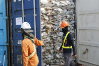 Workers open a container full of non-recyclable plastic detained by authorities at the west port in Klang, Malaysia, Tuesday, May 28, 2019. Malaysia environment minister Yeo Bee Yin says Malaysia has become a dumping ground for the world's plastic waste, and the country has begun sending non-recyclable plastic scrap to the developed countries of origin. (AP Photo/Vincent Thian)