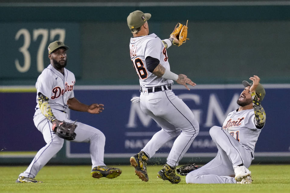 Detroit Tigers left fielder Akil Baddoo, left, watches as shortstop Javier Baez catches a fly ball hit by Washington Nationals' Jeimer Candelario, with center fielder Riley Greene at right, during the fifth inning of a baseball game at Nationals Park, Friday, May 19, 2023, in Washington. (AP Photo/Alex Brandon)