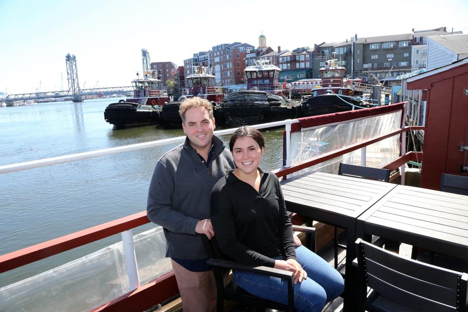Casey Anderson and his fiancée and restaurant manager, Halley Bushe, enjoy the Oar House deck, which overlooks the Piscataqua River in Portsmouth. The restaurant is celebrating its 50th anniversary in 2024.
