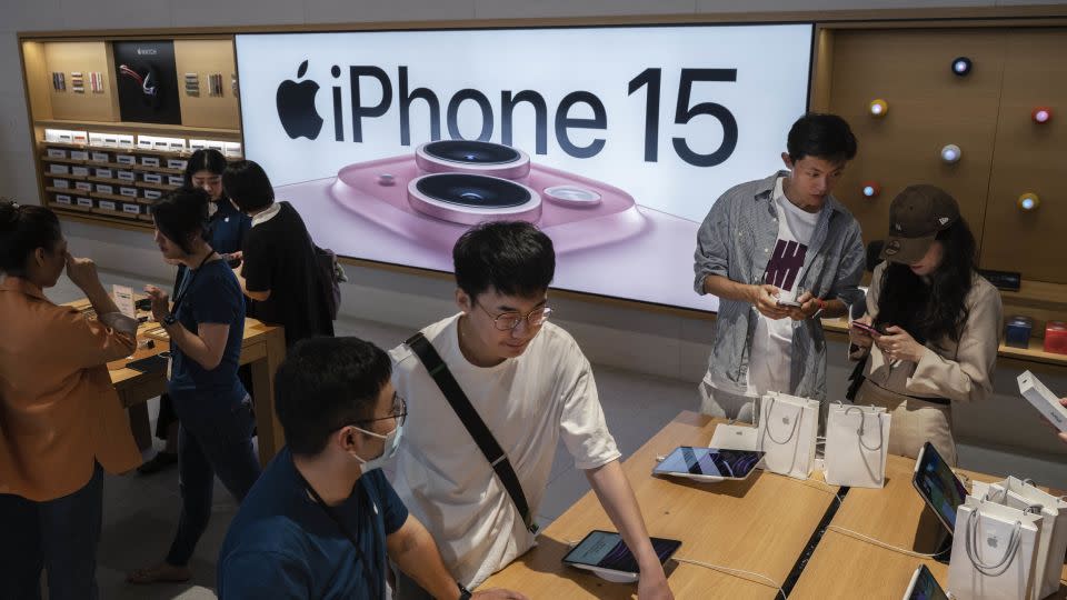 People browsing Apple products at a Beijing flagship store on September 22, 2023. - Kevin Frayer/Getty Images/File
