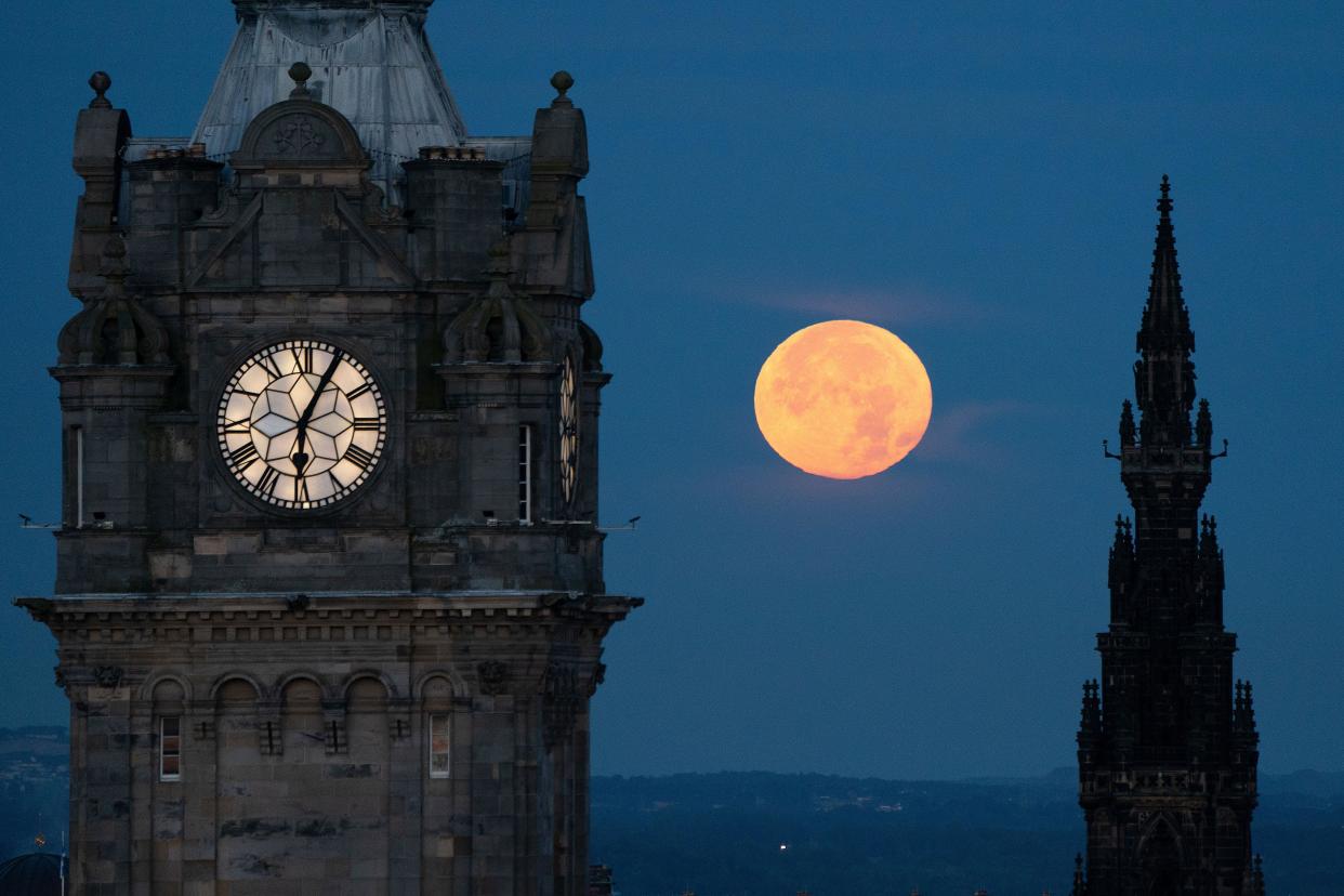 The super blue moon sets between the Balmoral Clock and the Scott Monument in Edinburgh. The blue moon refers to the second full moon in one calendar month, which occurs approximately once every two or three years. This one is also supermoon - when the Earth's natural satellite will appear about 14% bigger and 30% brighter in the sky as it reaches its closest point to Earth. Picture date: Thursday August 31, 2023.