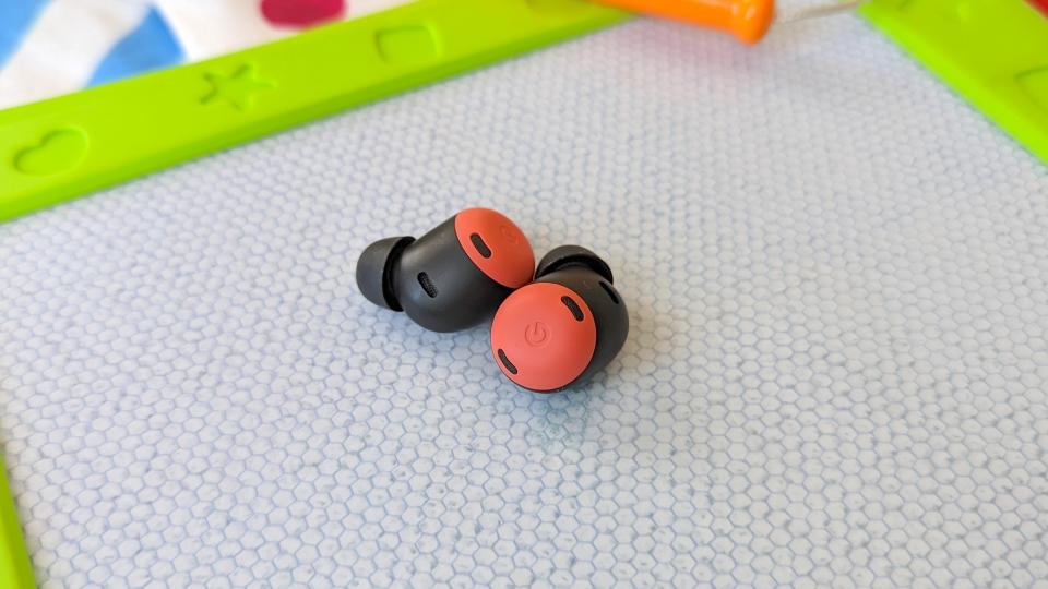 The Google Pixel Buds Pro wireless earbuds resting on an Etch-a-Sketch