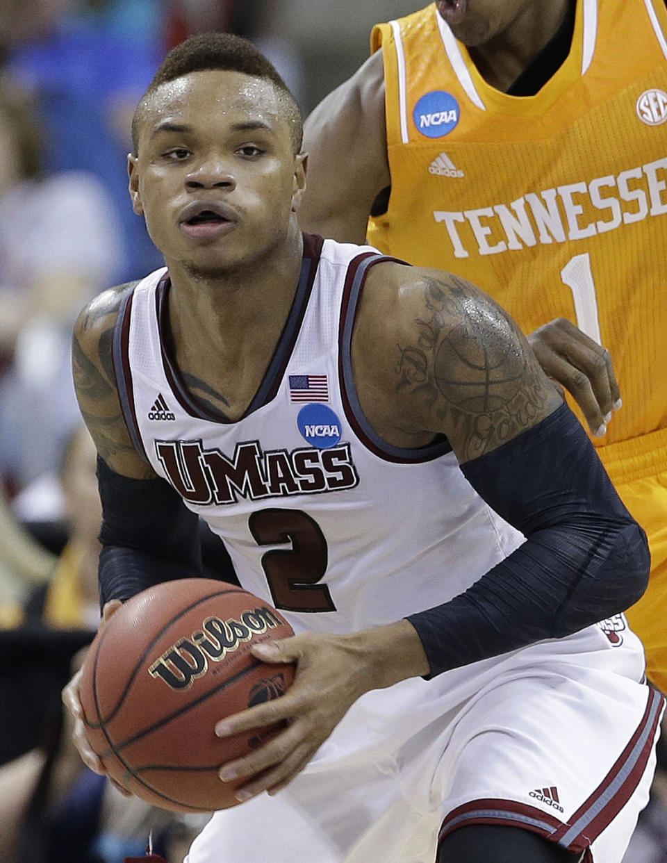 FILE - In this March 21, 2014 file photo, UMass guard Derrick Gordon (2) works against Tennessee guard Josh Richardson (1) during the first half of an NCAA college basketball second-round tournament game in Raleigh. Gordon says in a televised interview that he is gay. Gordon made the announcement on ESPN on Wednesday, April 9, 2014, becoming the first openly gay player in Division I men's basketball. (AP Photo/Gerry Broome, File)