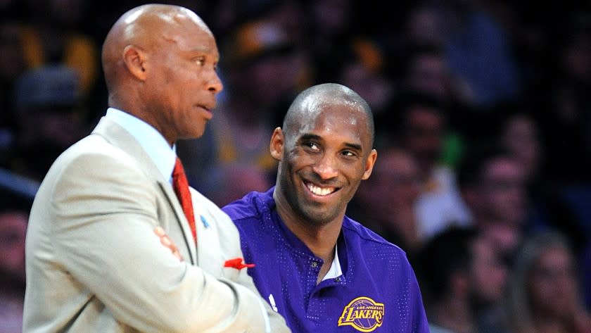 Lakers Coach Byron Scott chats with guard Kobe Bryant during a game against the Celtics on Sunday.