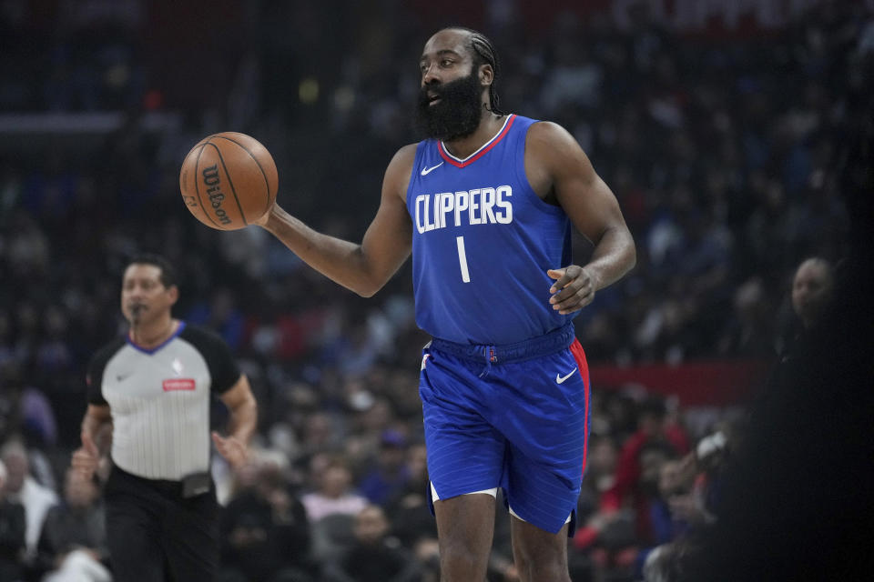 Los Angeles Clippers guard James Harden brings the ball up during the first half of the team's NBA basketball game against the Utah Jazz in Los Angeles, Friday, April 12, 2024. (AP Photo/Eric Thayer)